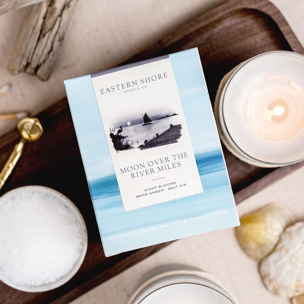 Moon over the River Miles candle illustration, Sailboat on the River Miles outside of St. Michaels in MD.  Eastern Shore Co. Candle box with candle on wooden tray. Hand poured in very small batches on the eastern shore. saint michaels, st. michaels, moon, moonlight, moonlit, amber scent, jasmine scent, night blooms scent, summer candle, sultry candle, Scented candle, coconut soy wax, coastal candle, eastern shore, Chesapeake Bay, luxury candle, hand-poured, Maryland, Virginia, 