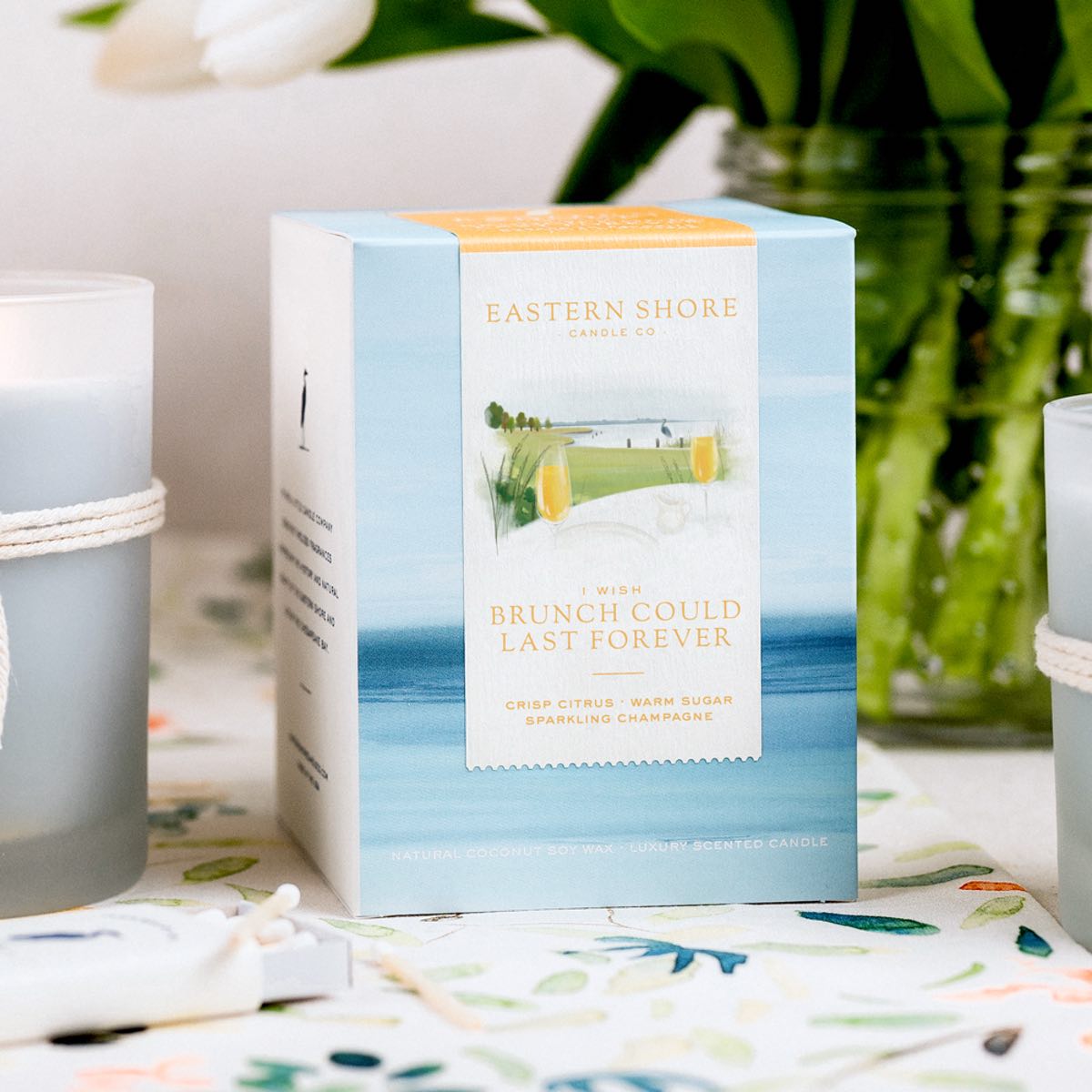 I Wish Brunch Could Last Forever Candle Box showing the illustration, Eastern Shore Co, Brunch, champagne, citrus, orange, cheers, bridesmaid, wedding gift, bridesmaid gift, crisp citrus, sparkling champagne, brunch candle, Scented candle, coconut soy wax, coastal candle, eastern shore, Chesapeake Bay, luxury candle, hand-poured in very small batches, Maryland, Virginia