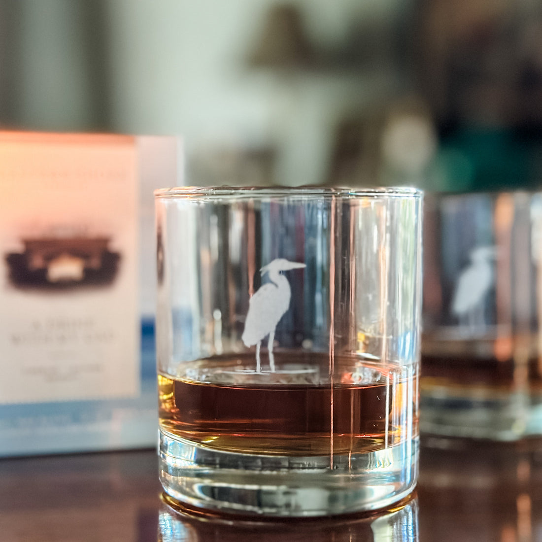 Glass with a heron engraving on a bar counter