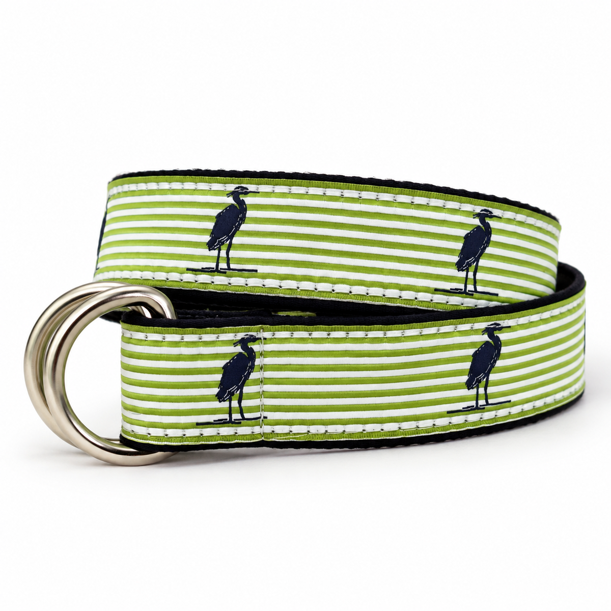A woven leather belt with soft green and white horizontal stripes, featuring navy blue heron silhouettes and a polished silver-tone metal D-ring buckle, shown on a white background.