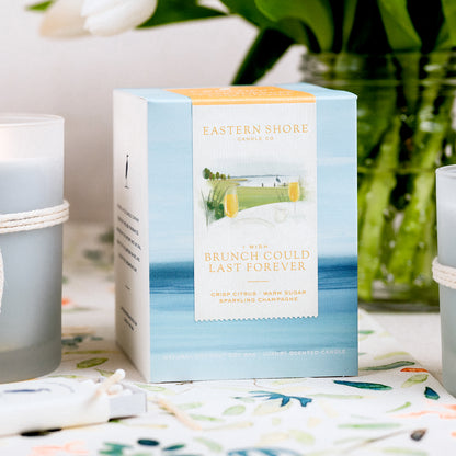I Wish Brunch Could Last Forever Candle Box showing the illustration, Eastern Shore Co, Brunch, champagne, citrus, orange, cheers, bridesmaid, wedding gift, bridesmaid gift, crisp citrus, sparkling champagne, brunch candle, Scented candle, coconut soy wax, coastal candle, eastern shore, Chesapeake Bay, luxury candle, hand-poured in very small batches, Maryland, Virginia