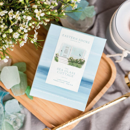 The Sea Glass Cottage candle box  - coconut soy wax candle - cottage garden scent, seaside garden, geranium, jasmine, gardenia, roses, lily, magnolia, peony, seaside air, sea breeze, Scented candle, coastal candle, eastern shore, Chesapeake Bay, luxury candle, hand-poured, Maryland, Virginia, 10 oz candle box on a wooden tray