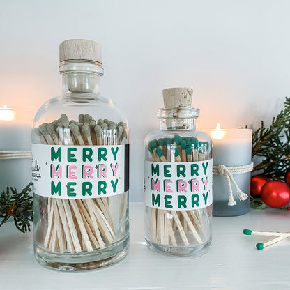 Two glass bottles with cork lids containing matches, labeled &